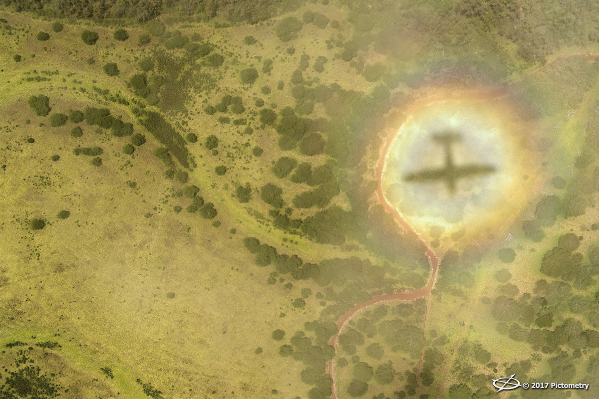 clouds and rainbows over Maui reveal the shadow of a plane capturing Pictometry imagery