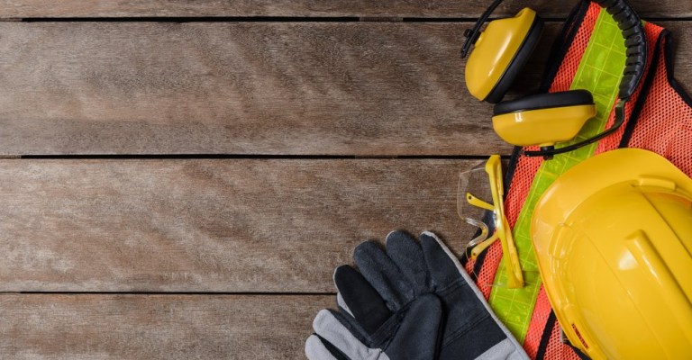 construction safety gear: hardhat, gloves, goggles, vest, ear protection