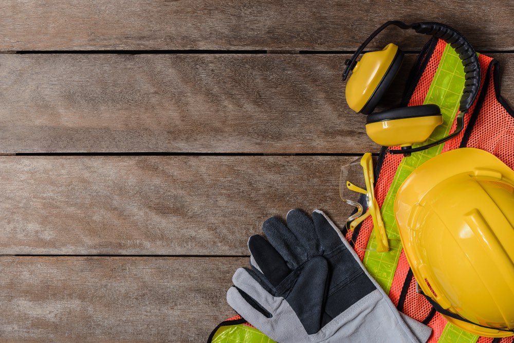 construction safety gear: hardhat, gloves, goggles, vest, ear protection