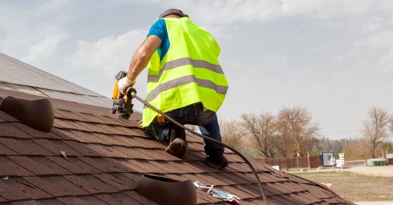 Roofer on roof working