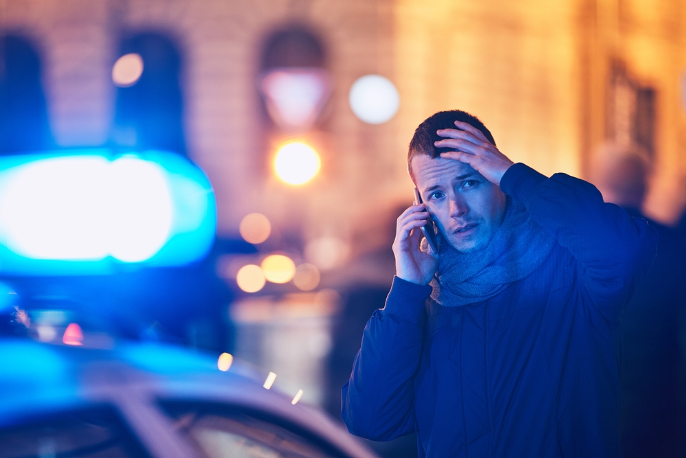 A man on the phone with public safety telecommunicators