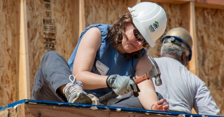 A roofer works on a home for Habitat for Humanity.
