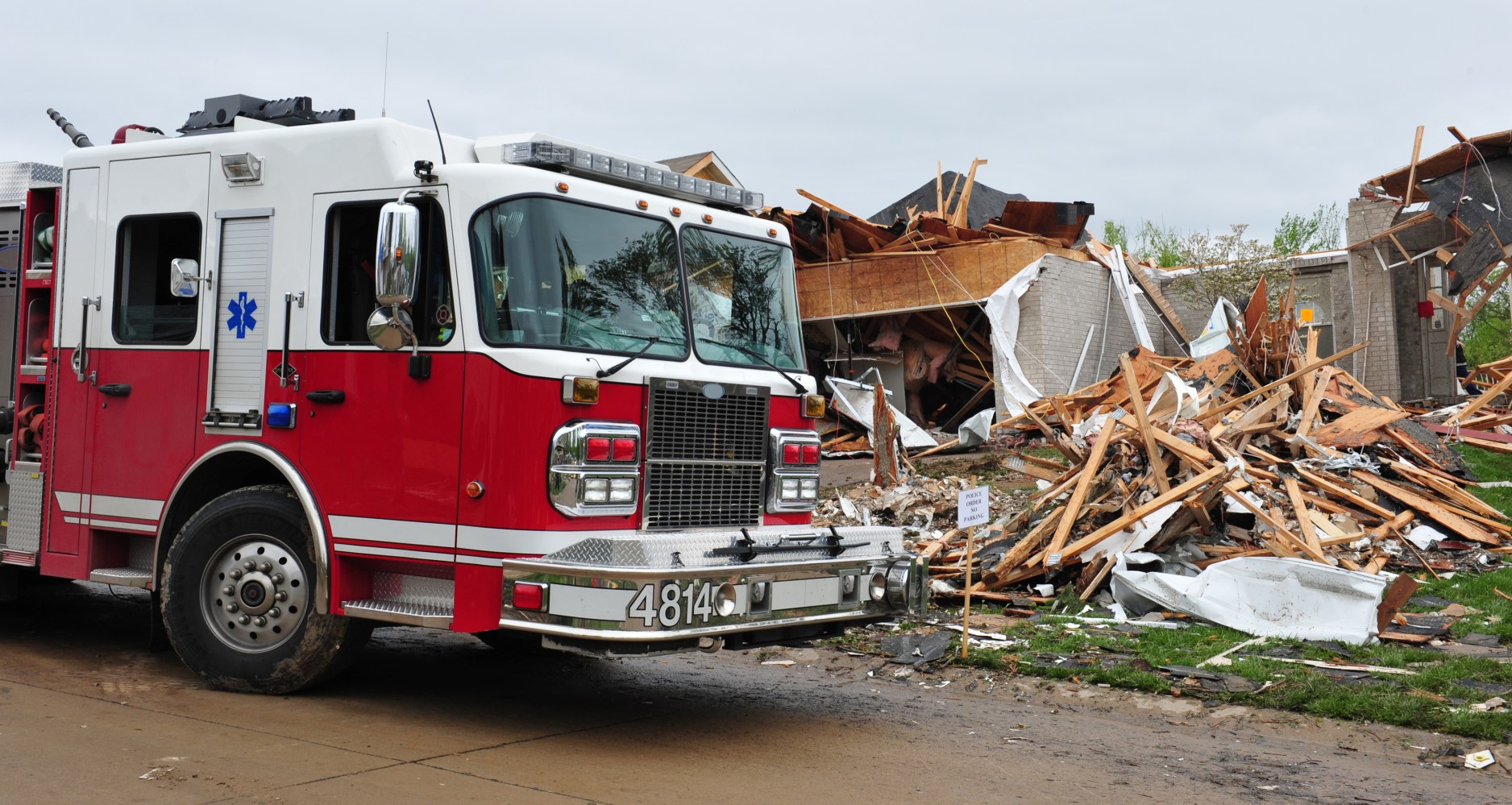 Fire truck parked outside wrecked building