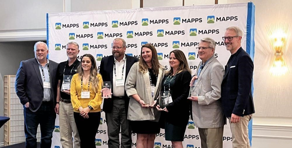 Group of EagleView employees holding an award received at MAPPS.