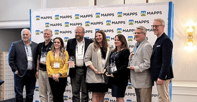 Group of EagleView employees holding an award received at MAPPS.