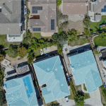 Aerial image of roofs of single family homes on a sunny day.
