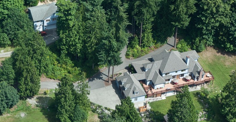 aerial view of single family home in forest