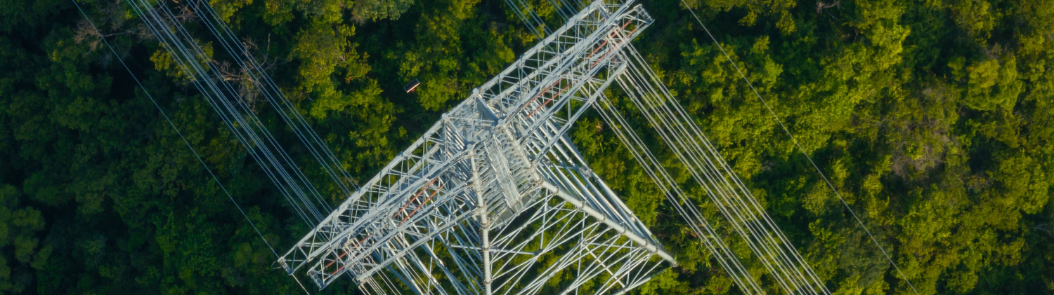Aerial view of high voltage electricity tower over mountain