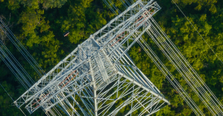 Aerial view of high voltage electricity tower over mountain