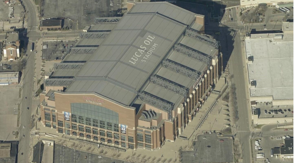 Aerial view of Lucas Oil Stadium showing the full roof and surrounding city streets.