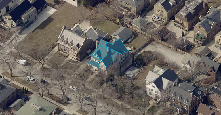 Oblique image of a residential home featuring a turquoise outline of the roof.